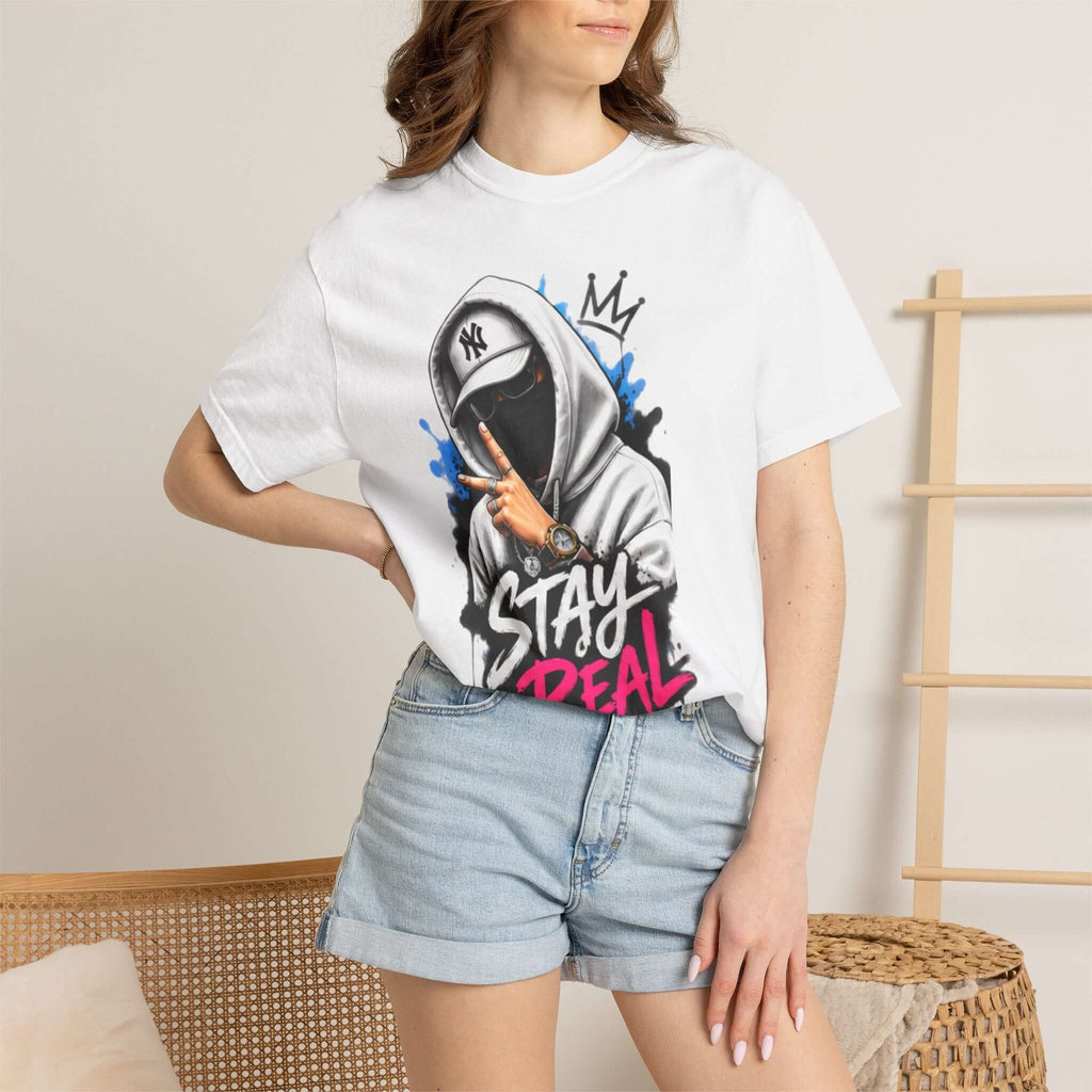 Unisex Garment-Dyed T-shirt featuring graphic design with 'STAY REAL' text worn with denim shorts.