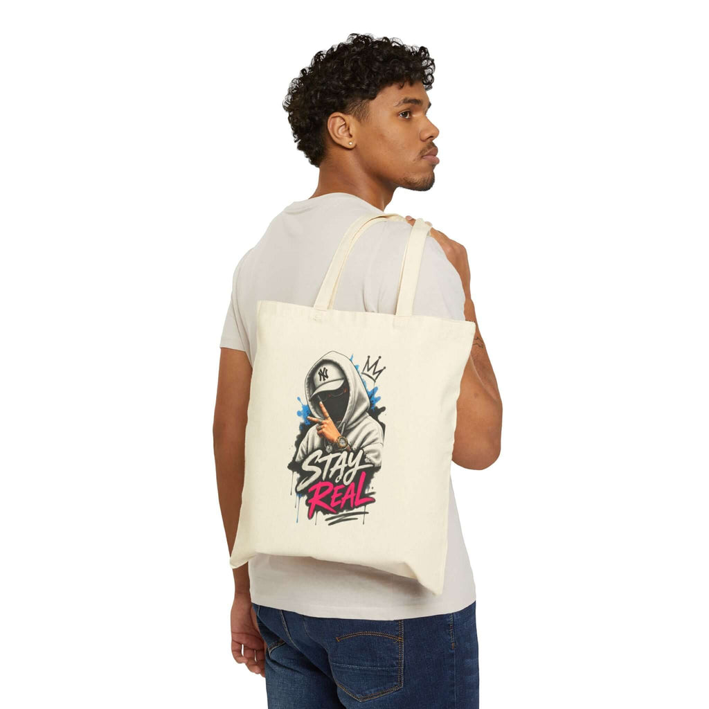 Durable cotton canvas tote bag featuring graffiti-style art and text, perfect for stylish everyday carry.
