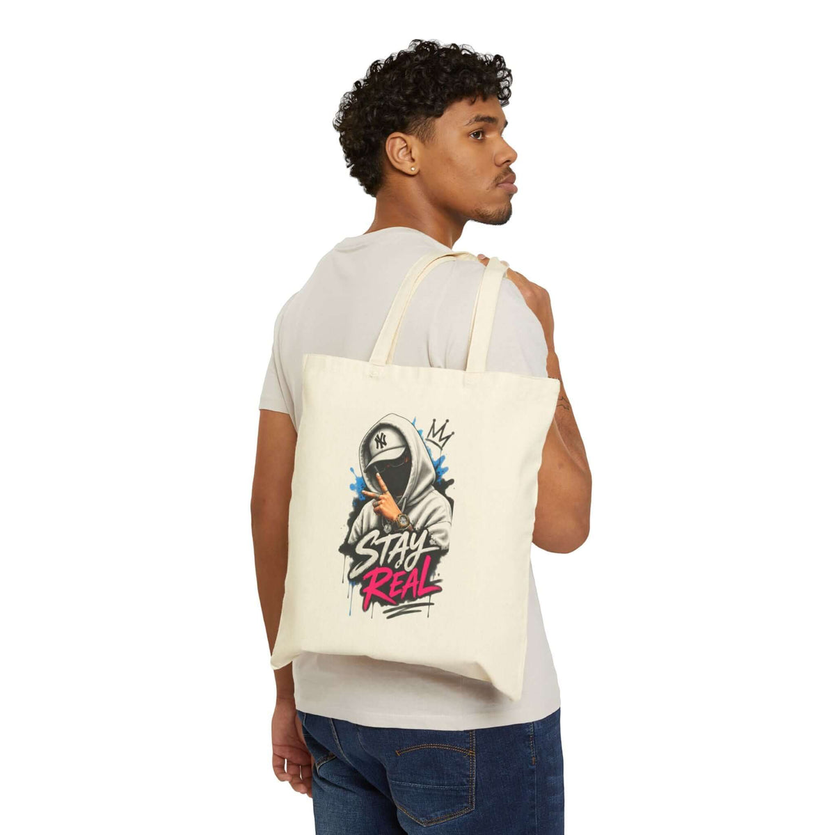 Durable cotton canvas tote bag featuring graffiti-style art and text, perfect for stylish everyday carry.