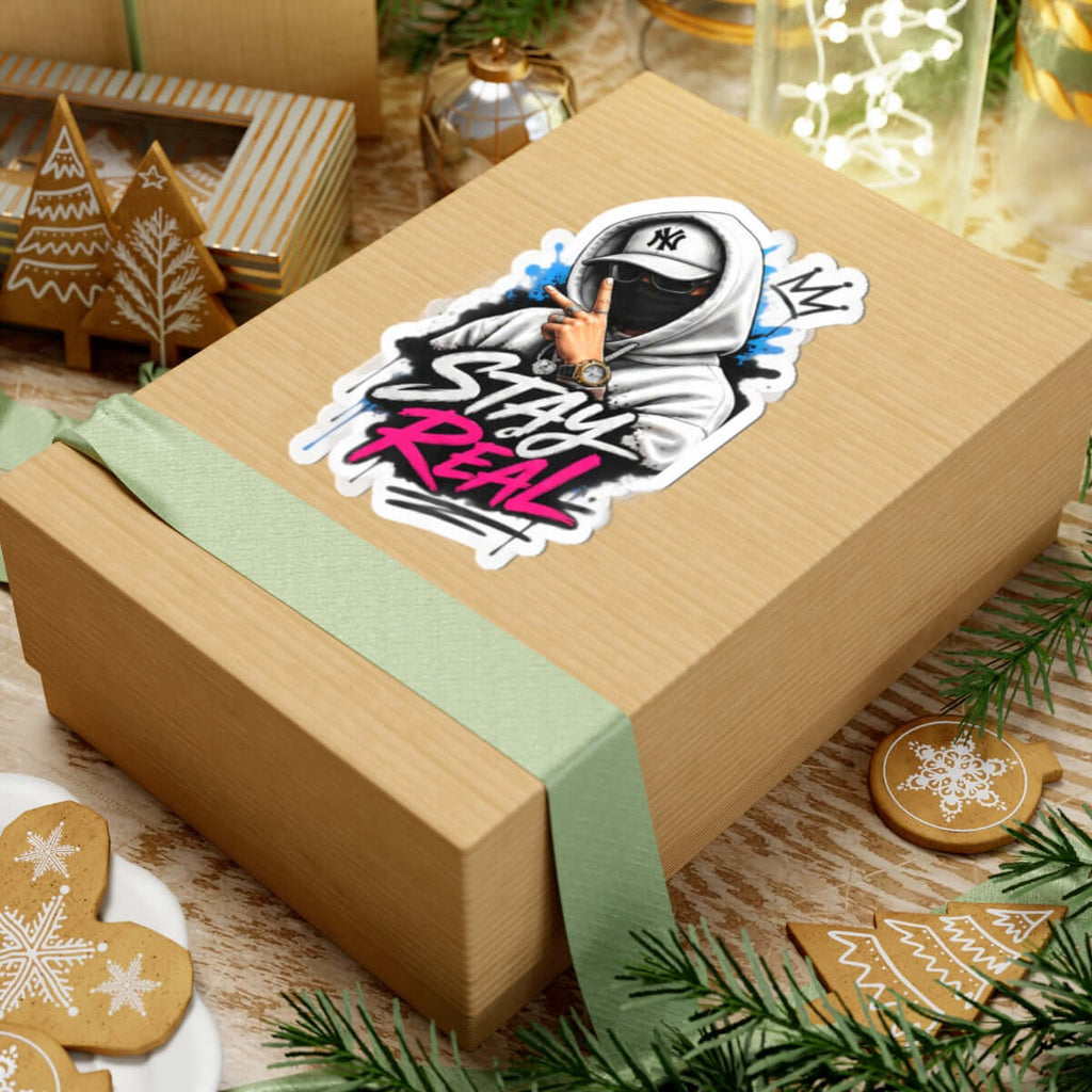 Custom kiss-cut stickers on a gift box with a cool design and a green ribbon, perfect for personal projects.