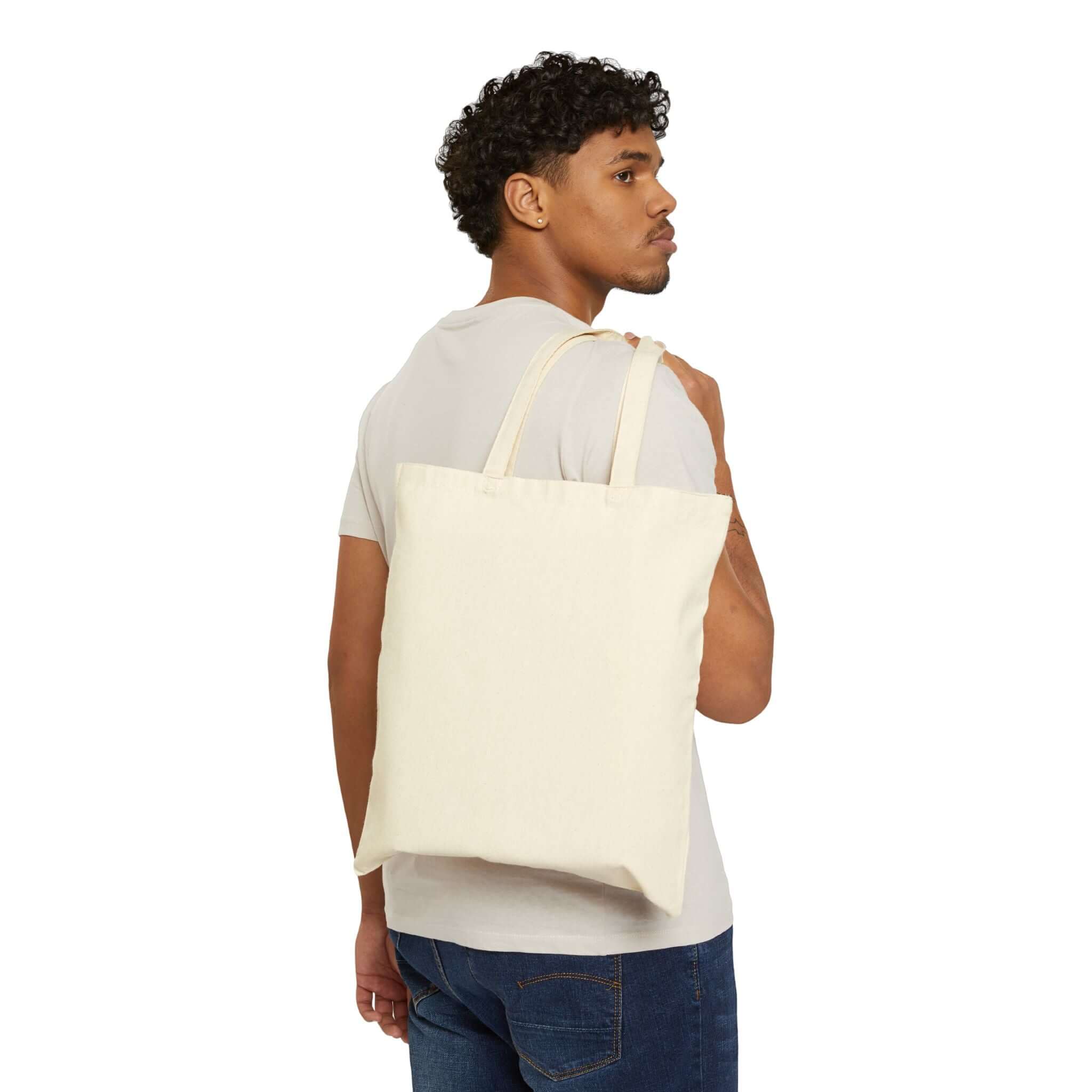 Stylish man holding a durable cotton canvas tote bag on his shoulder, perfect for everyday use.