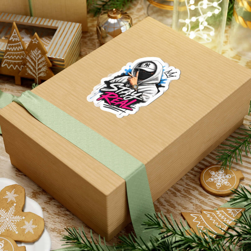 Custom kiss-cut stickers on a gift box with green ribbon, showcasing creative design in a festive setting.